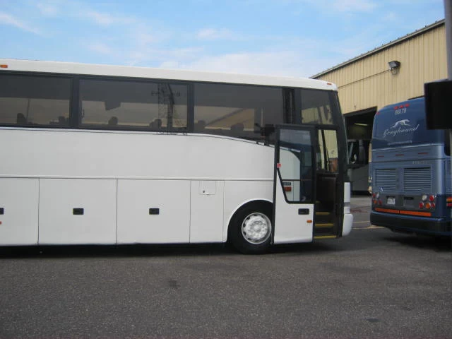 White 56-passenger coach bus rental