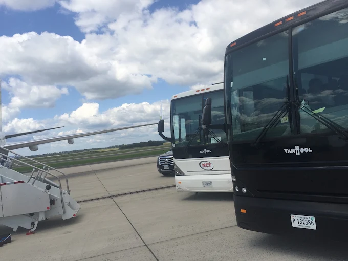 Charter coach bus on the airport tarmac for a group transfer